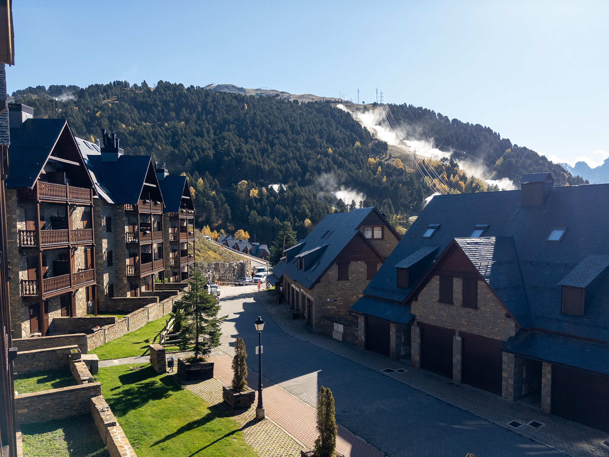 Rooftops of Baqueira with the ski slopes rising behind