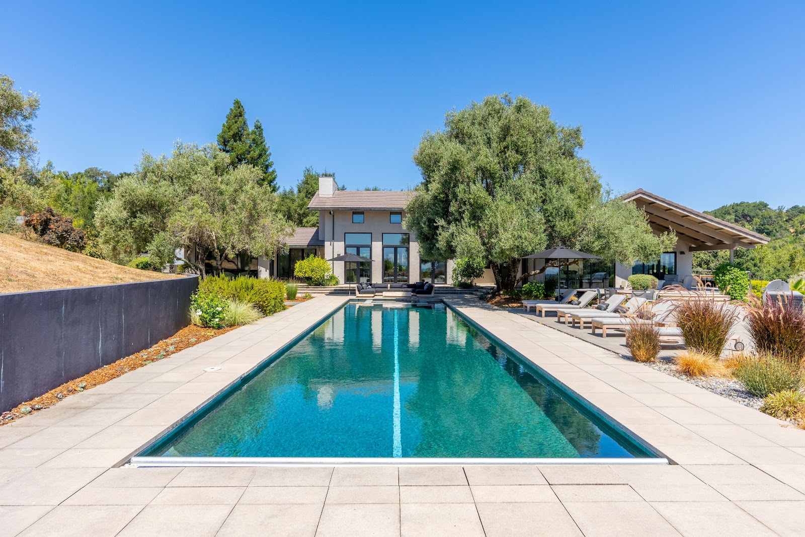 A Napa Valley estate with a pool, surrounded by vineyards and rolling hills