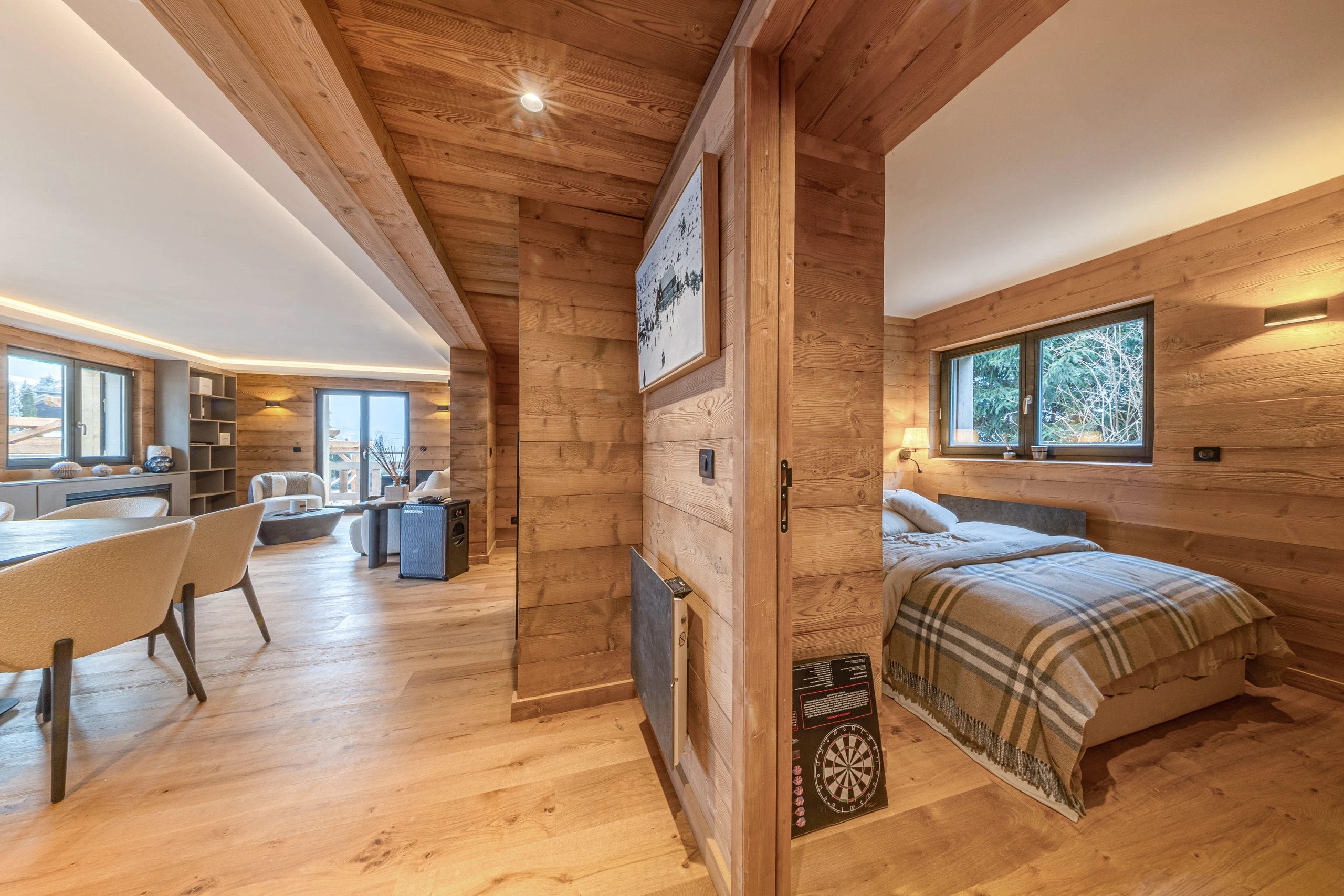 Timber-lined living area and separate bedroom in the Rochebrune Retreat apartment
